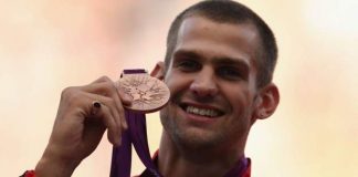 Robbie Grabarz loses a medal while waiting for silver.