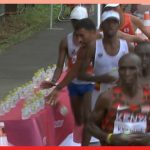 Marathon runner knocks over line of water bottles