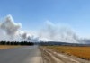 a wildfire and strong winds